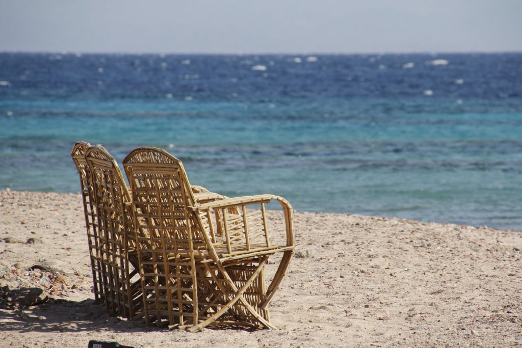 Rattanmöbel an Sandstrand am Meer